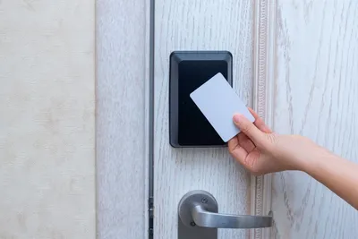A person using a keycard to unlock a door